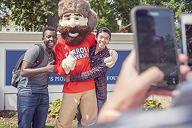Students posing with mascot. Link to Gifts of Life Insurance